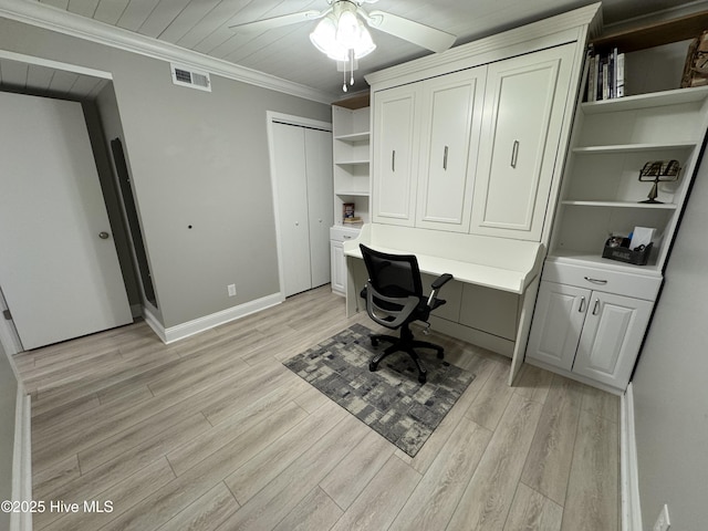 office area with built in desk, ornamental molding, ceiling fan, and light wood-type flooring