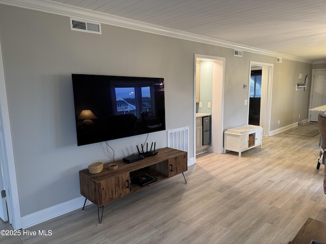 living room featuring ornamental molding and light wood-type flooring