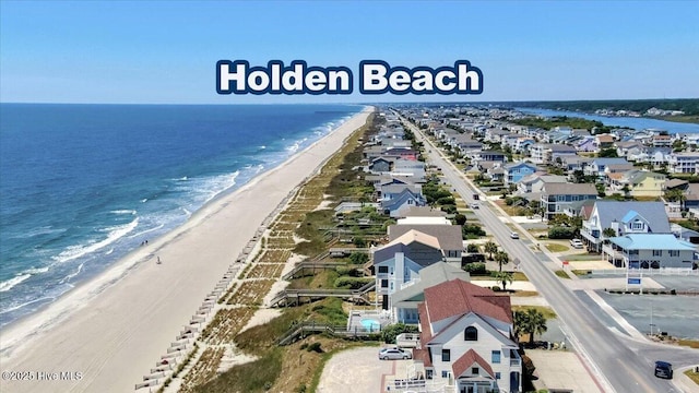 drone / aerial view with a water view and a view of the beach