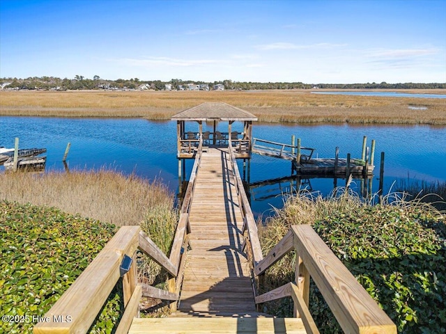 view of dock featuring a water view and a gazebo