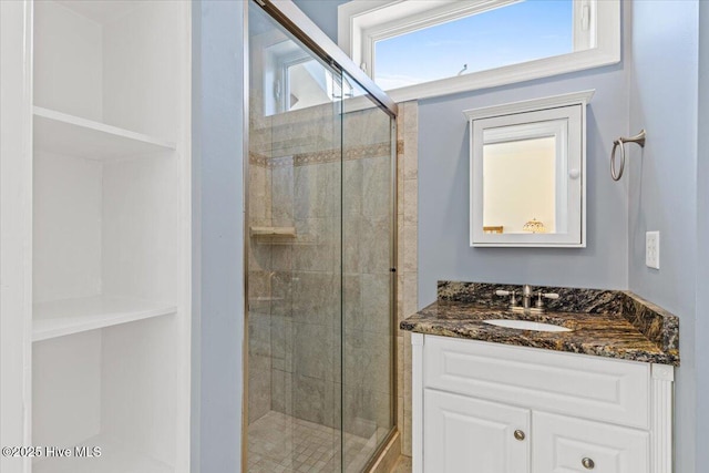 bathroom with a stall shower and vanity