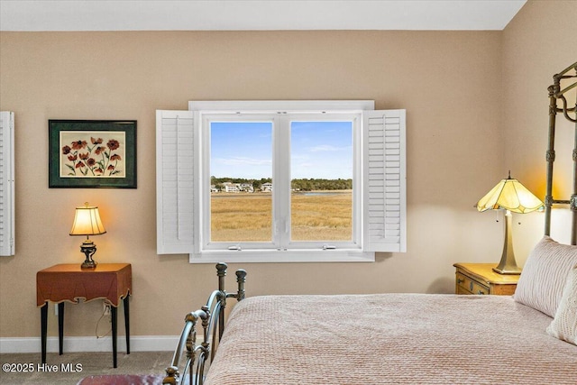 carpeted bedroom featuring baseboards