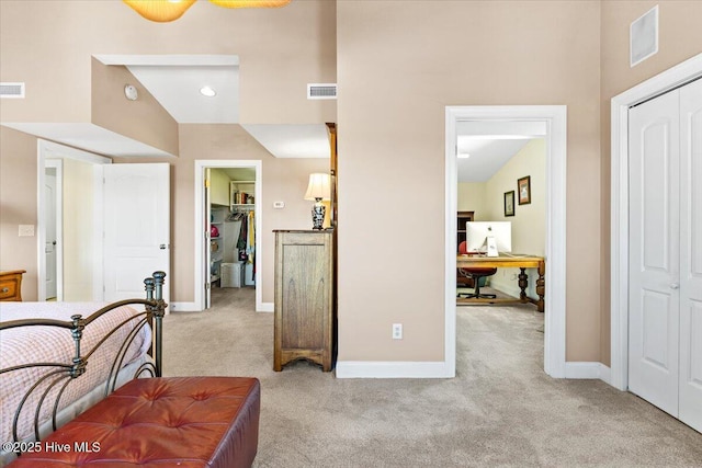 bedroom with a closet, visible vents, baseboards, and carpet flooring