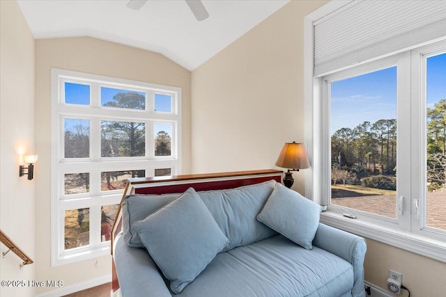 interior space featuring a wealth of natural light, vaulted ceiling, baseboards, and a ceiling fan