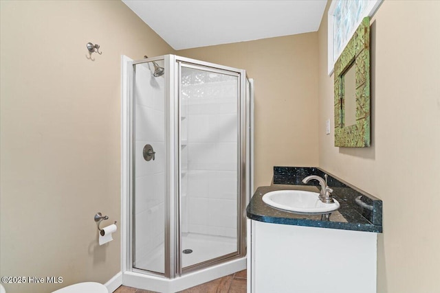 bathroom featuring a shower stall and vanity