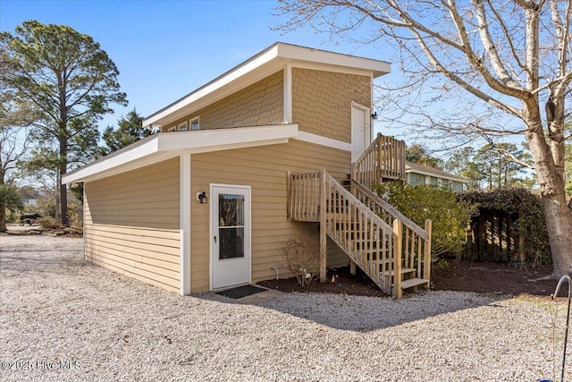 rear view of property featuring stairway