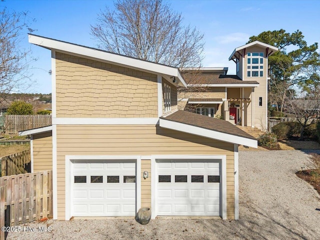exterior space with driveway and fence