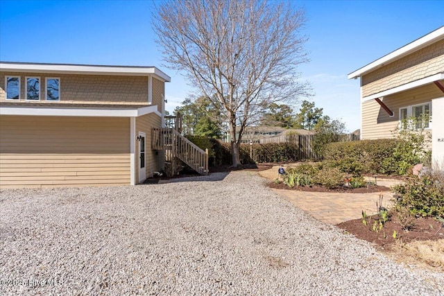 view of side of property with stairs and a patio area