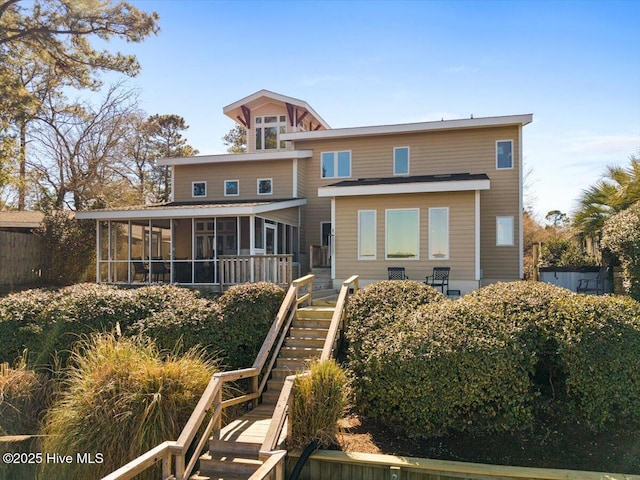 back of house with a sunroom and stairs