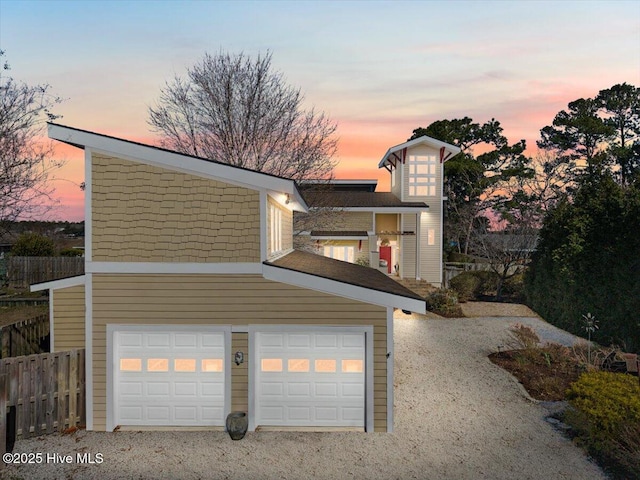 view of front of property with a garage and fence