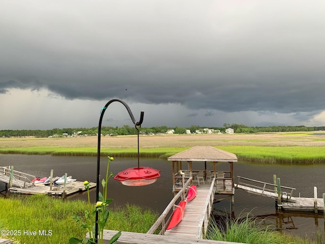 view of dock featuring a water view and a gazebo