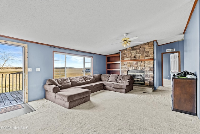 living room with light colored carpet, a stone fireplace, vaulted ceiling, and a textured ceiling