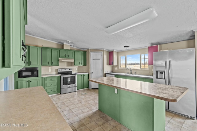 kitchen with sink, green cabinetry, a textured ceiling, appliances with stainless steel finishes, and ornamental molding