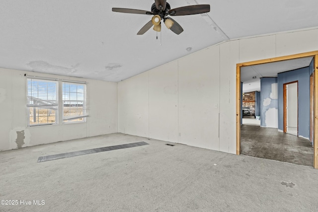 unfurnished room featuring lofted ceiling, ceiling fan, and carpet