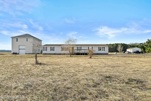 view of front of home with a wooden deck, a garage, and a front yard