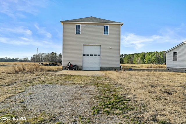 rear view of house featuring a garage