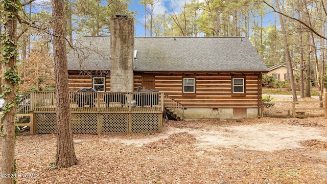 back of house featuring a wooden deck