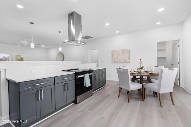 kitchen featuring island range hood, stainless steel range with electric cooktop, light countertops, gray cabinetry, and pendant lighting