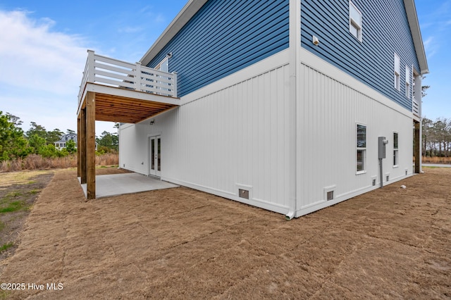 view of side of property featuring a patio area