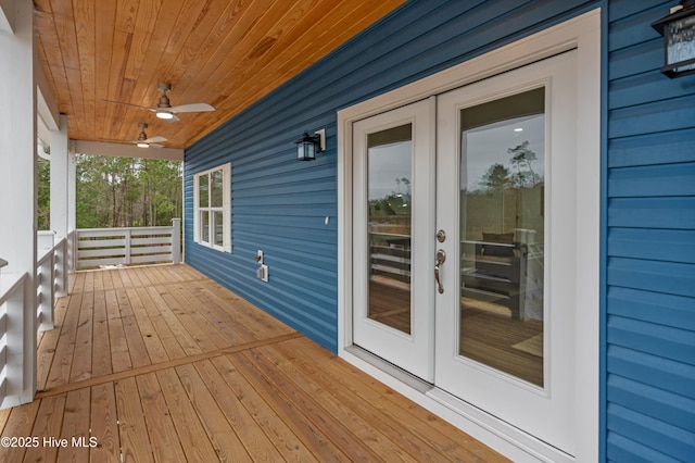 wooden terrace featuring ceiling fan and french doors