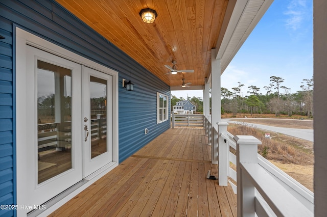 deck with french doors, a porch, and a ceiling fan