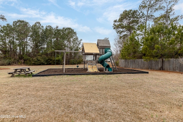 community play area with a yard and fence