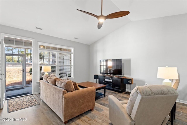 living room with lofted ceiling, hardwood / wood-style floors, and ceiling fan