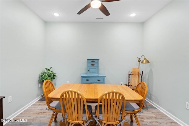 dining area with ceiling fan and light wood-type flooring