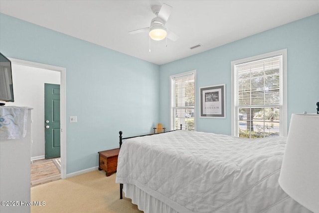 bedroom with light colored carpet and ceiling fan