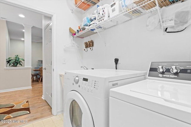 washroom featuring washer and dryer and light wood-type flooring