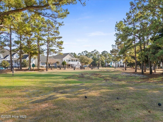 view of home's community with a yard