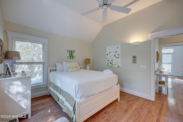 bedroom featuring vaulted ceiling, ceiling fan, and light wood-type flooring