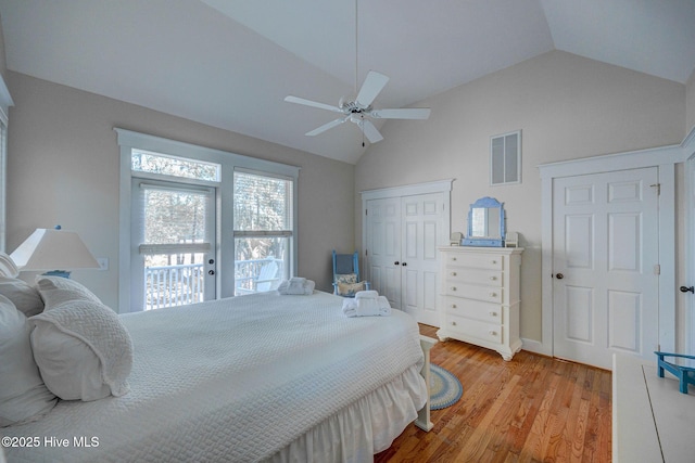 bedroom with vaulted ceiling, light hardwood / wood-style floors, a closet, and ceiling fan