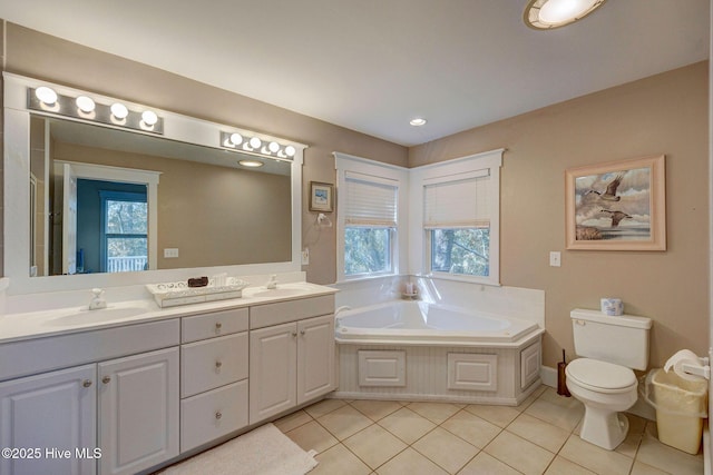 bathroom featuring vanity, plenty of natural light, a bath, and tile patterned floors