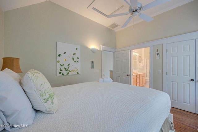 bedroom with hardwood / wood-style flooring, ensuite bath, ceiling fan, and vaulted ceiling