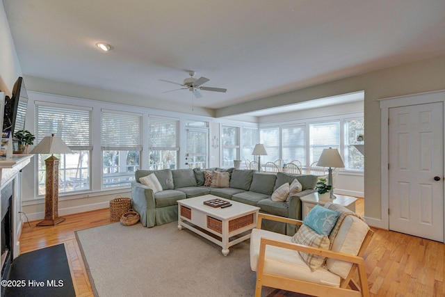 living room featuring ceiling fan and light wood-type flooring