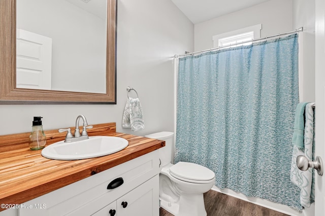 bathroom with vanity, hardwood / wood-style flooring, toilet, and a shower with shower curtain