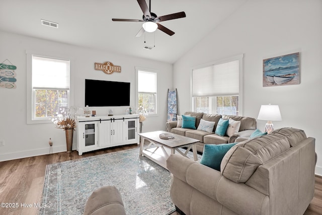 living room featuring ceiling fan, lofted ceiling, and wood-type flooring