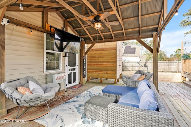 deck with ceiling fan and an outdoor living space