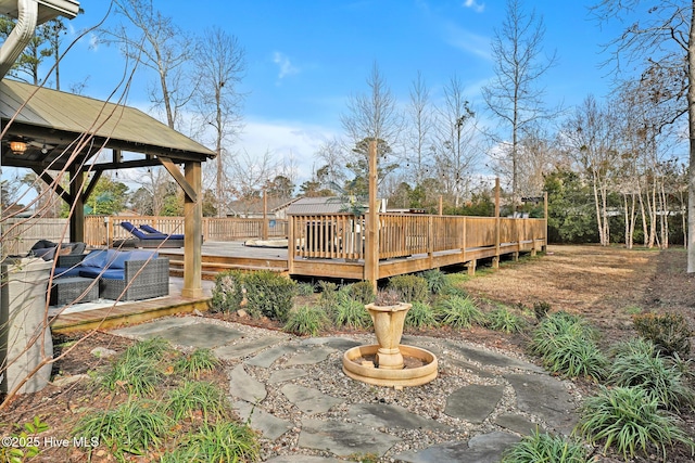 view of patio / terrace with a wooden deck, a gazebo, and outdoor lounge area