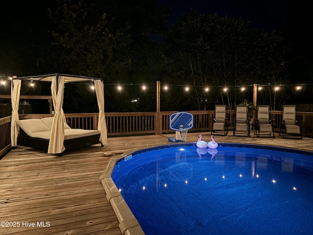 pool at night with a deck