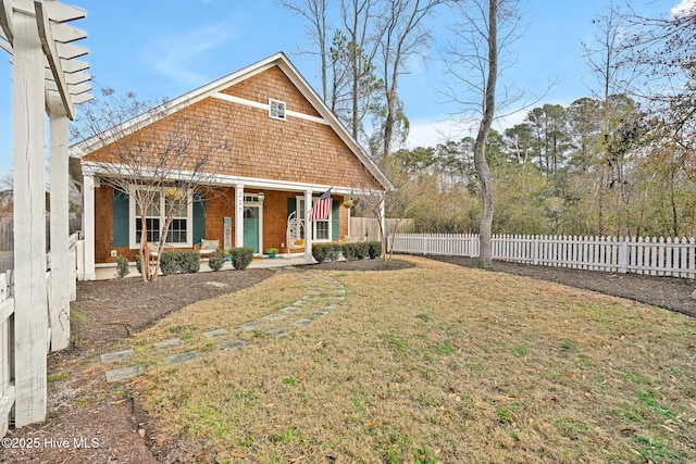 view of front of house with a front yard and a porch