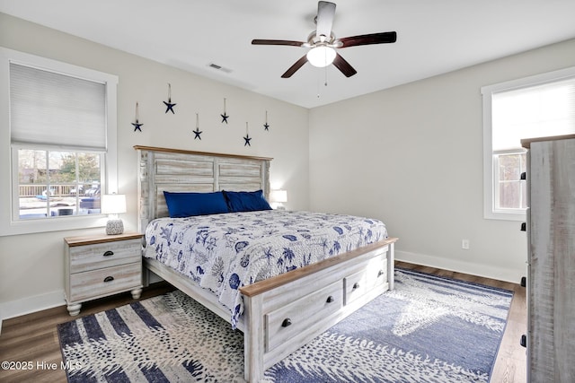 bedroom with dark hardwood / wood-style floors and ceiling fan