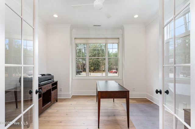 office space with crown molding, ceiling fan, light hardwood / wood-style floors, and french doors