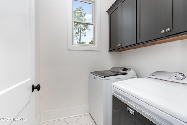 laundry area featuring cabinets and separate washer and dryer