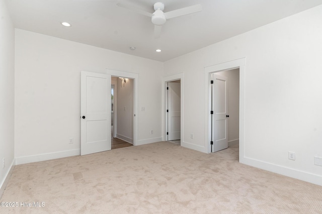 unfurnished bedroom featuring light carpet and ceiling fan