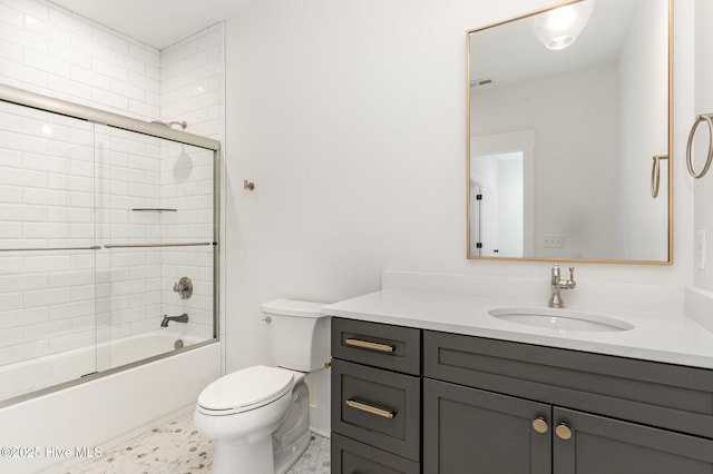 full bathroom featuring shower / bath combination with glass door, vanity, and toilet