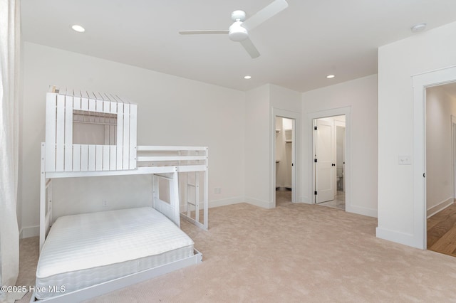 carpeted bedroom with ceiling fan and a spacious closet