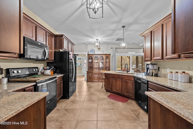 kitchen featuring hanging light fixtures, sink, light tile patterned floors, and black appliances