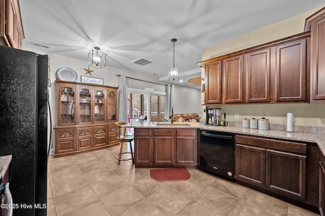 kitchen with sink, light tile patterned floors, black appliances, decorative light fixtures, and kitchen peninsula